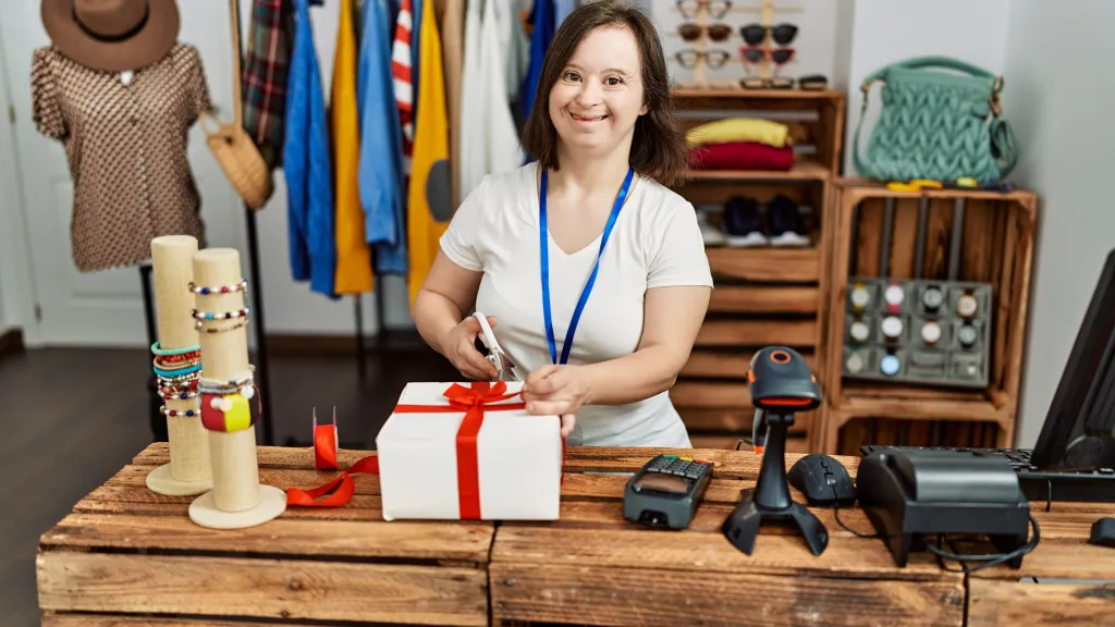 Retail worker wrapping a purchase at the shop counter