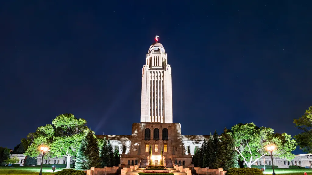 Nebraska State Capitol tower in Lincoln lit up at night